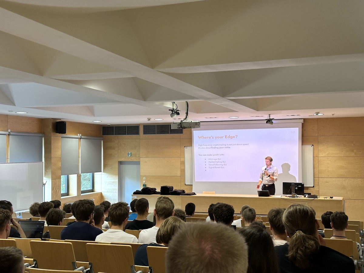Michal Juhás speaking to a full lecture hall